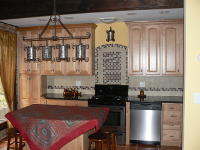 kitchen picture, kitchen cabinets, island kitchen table, dishwasher, kitchen lighting, flooring  in the kitchen, chairs